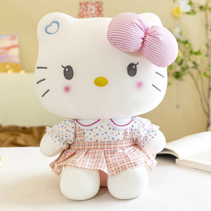 Söt Hello Kitty-plysch som sitter framför en bok